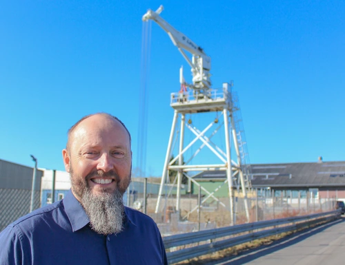 Liftra CEO Per Fenger in front of self-hoisting crane at Liftra headquarters in Aalborg